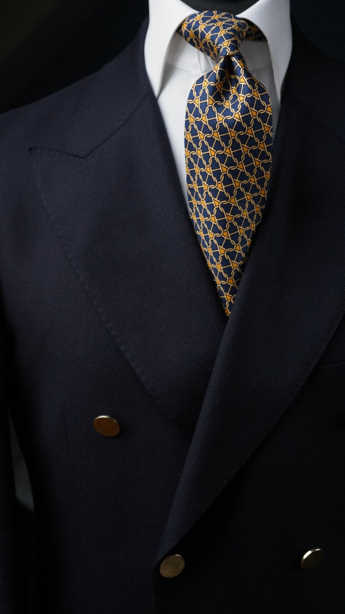 Cosima navy chain-link silk tie with a navy double-breasted blazer