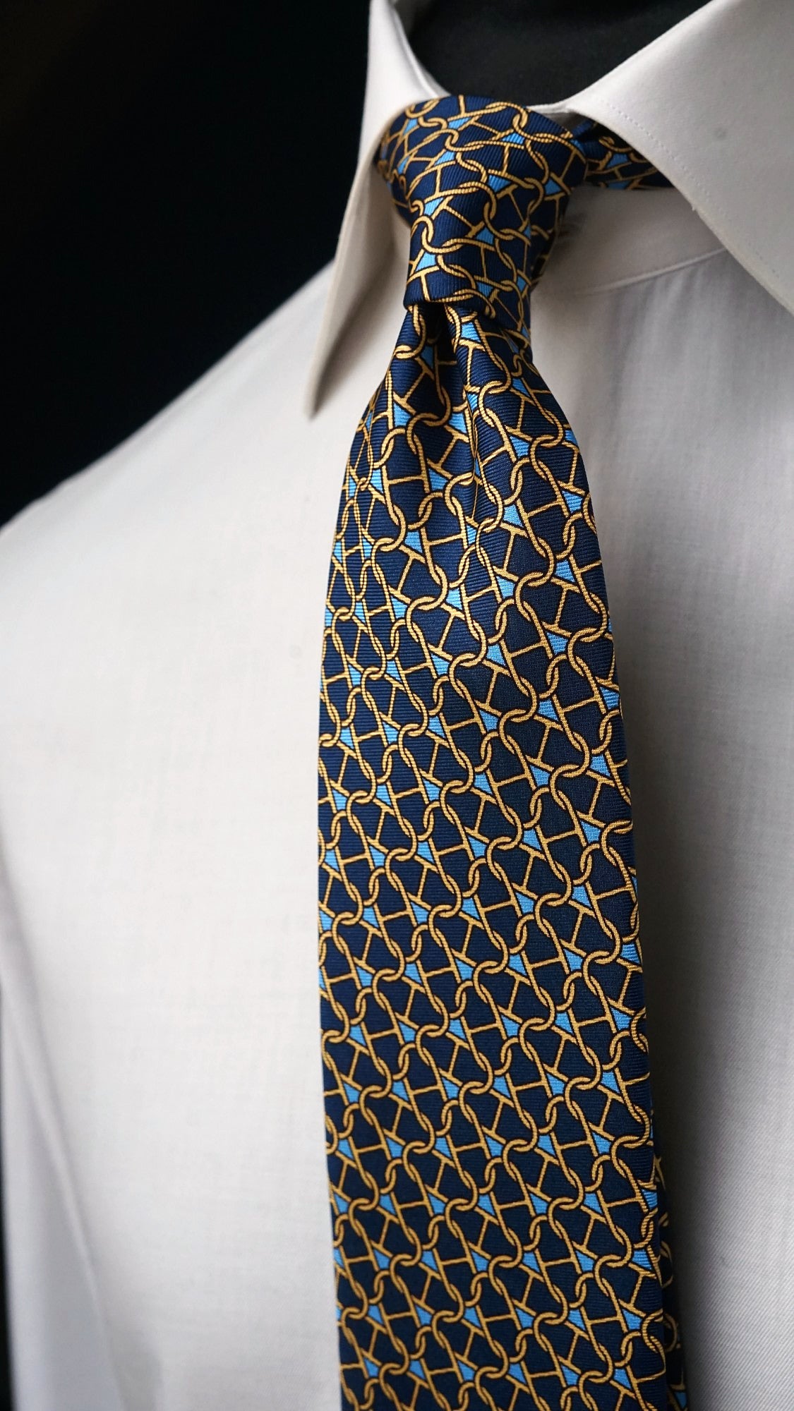 Marcella navy chain-link silk tie, angled view