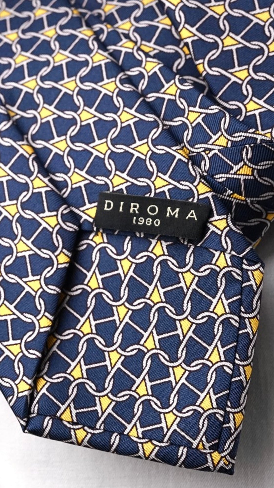 DIROMA 1980 label on the Tecla navy chain-link silk tie