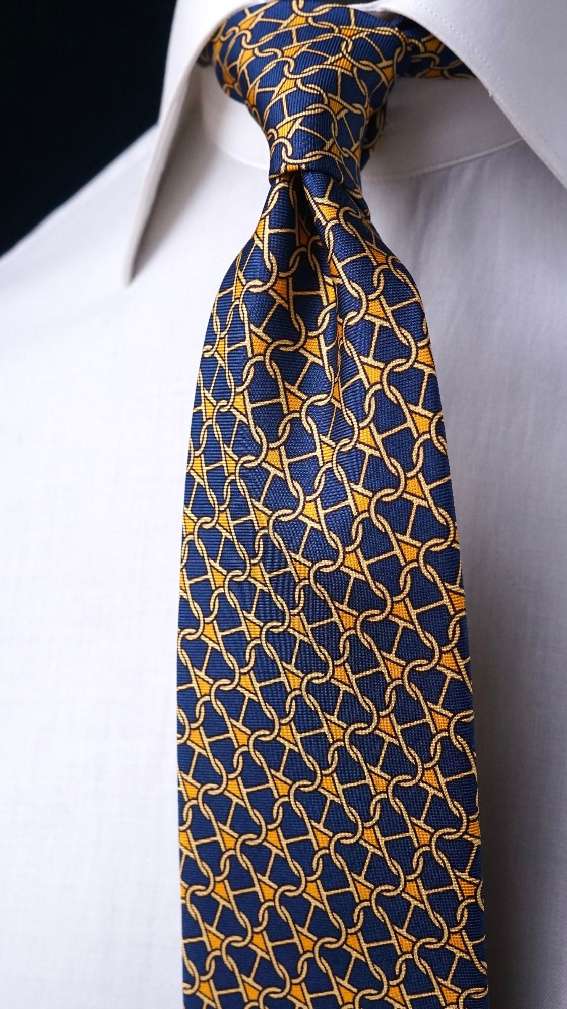 Close-up of the Cosima navy chain-link silk tie knot