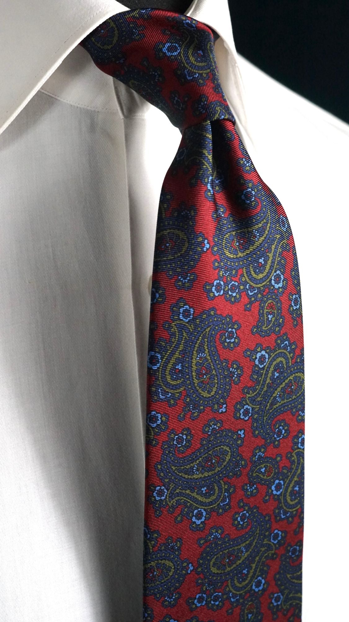 Germana red paisley silk tie knotted on a white shirt