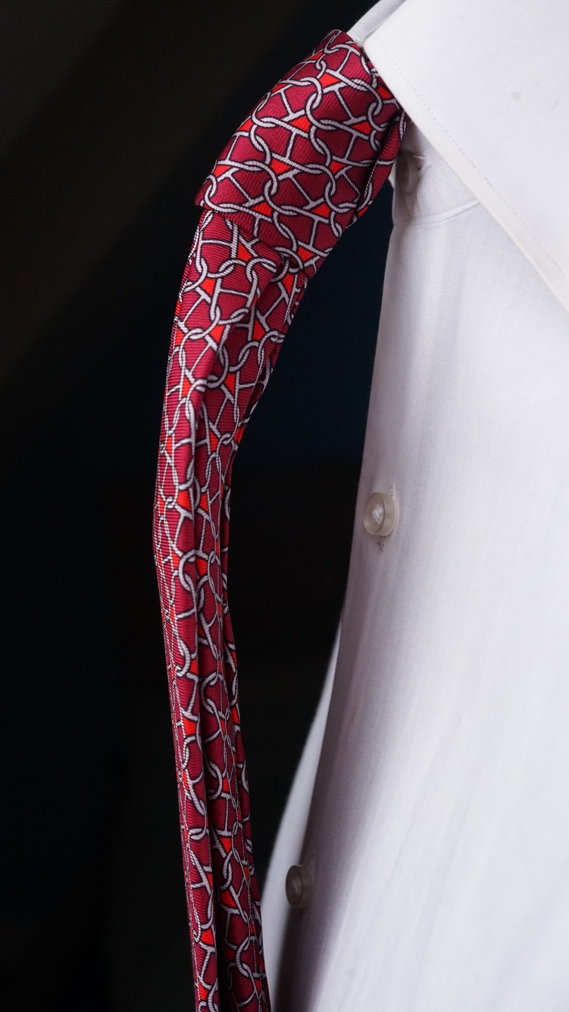 Side view of the Rosalba red chain-link silk tie